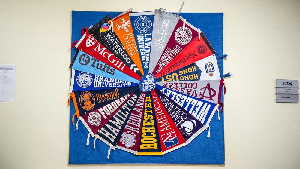 A mural of college flags in the university advising center